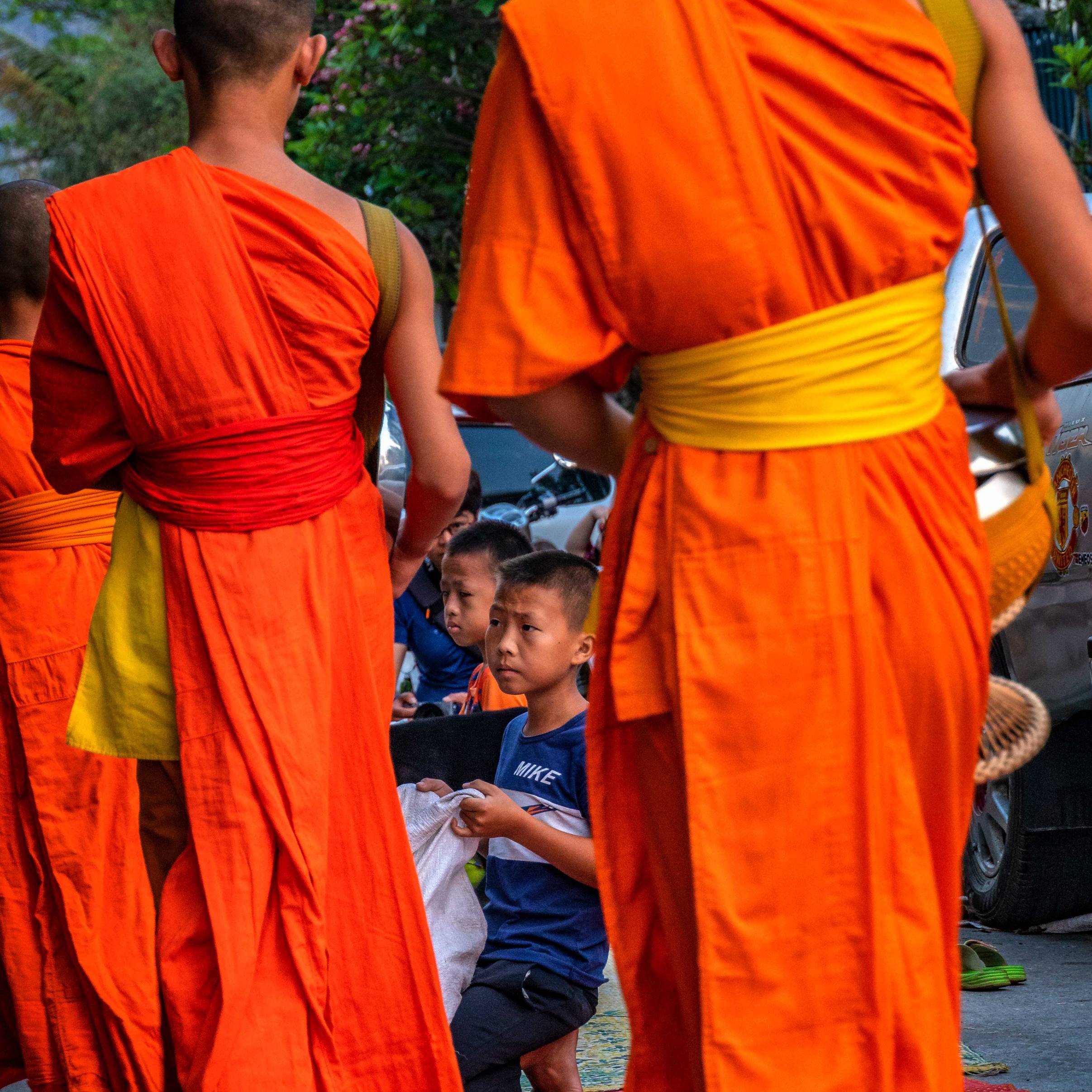 MONKS GIVING ALMOSES IN LUANG PRABANG