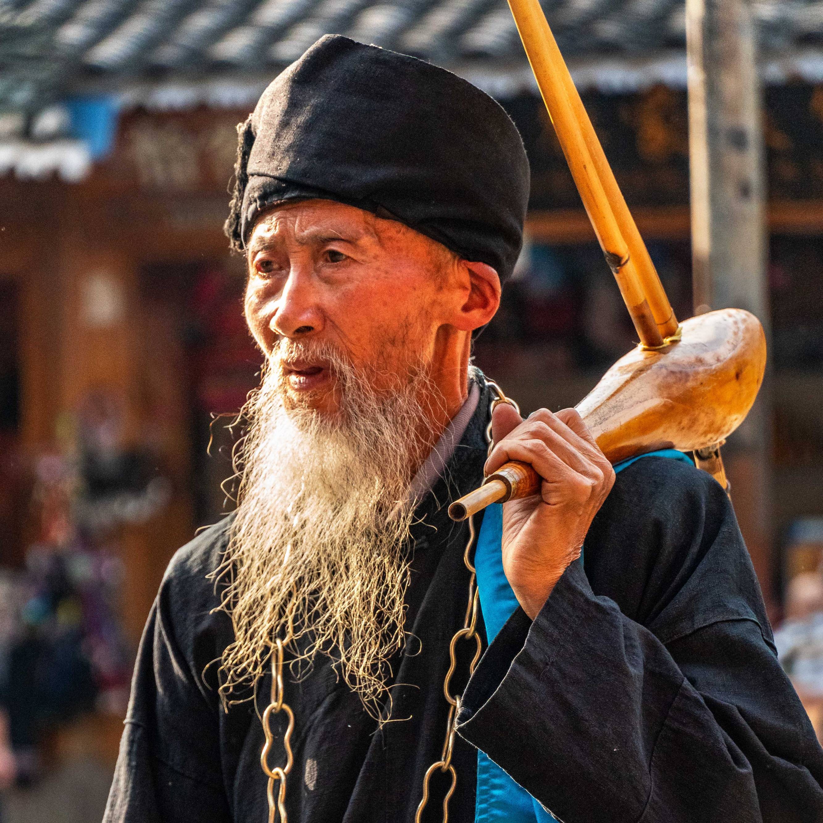 Man wearing traditional clothes and instrument, Dong Village, Province Yunnan