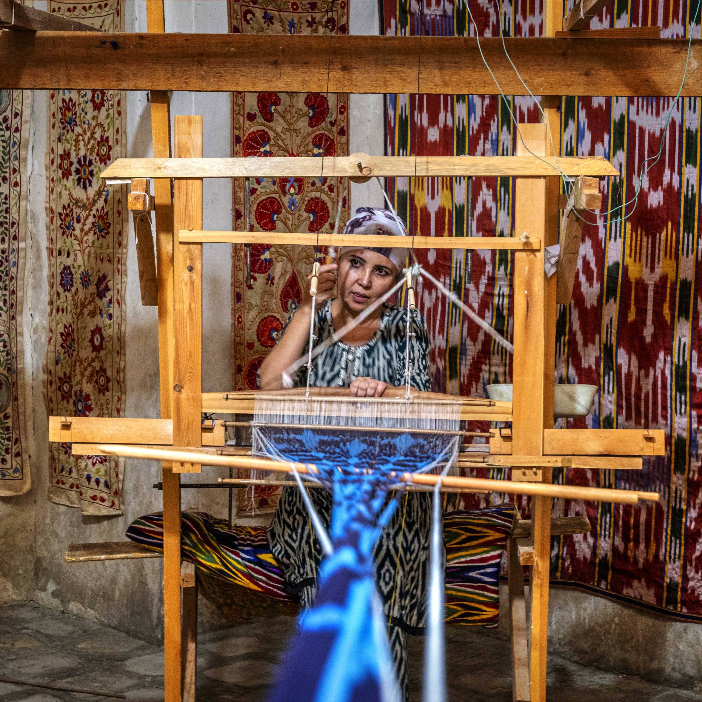 A woman weaving on the bazar