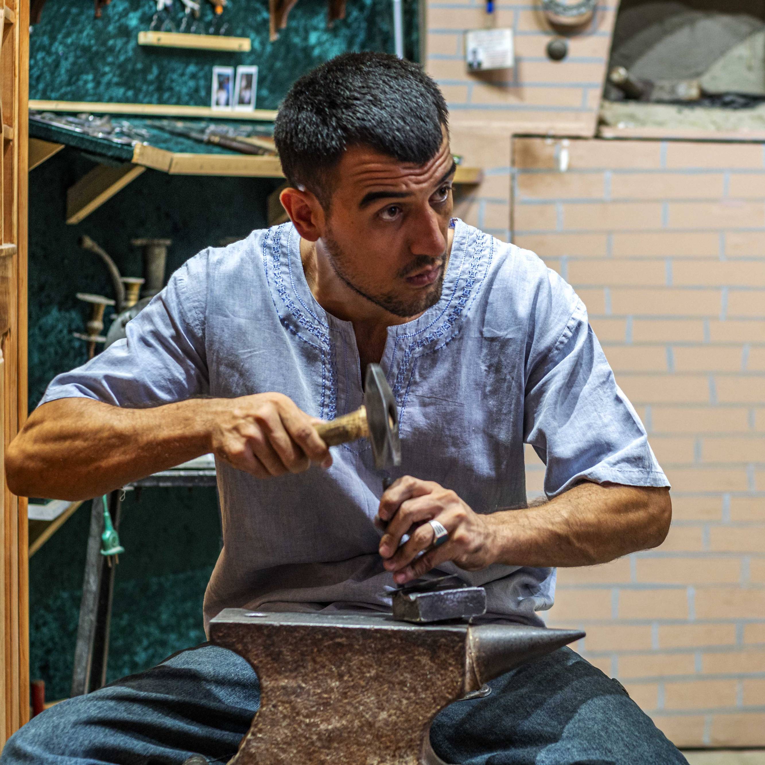 A craftsman working on handmade knifes