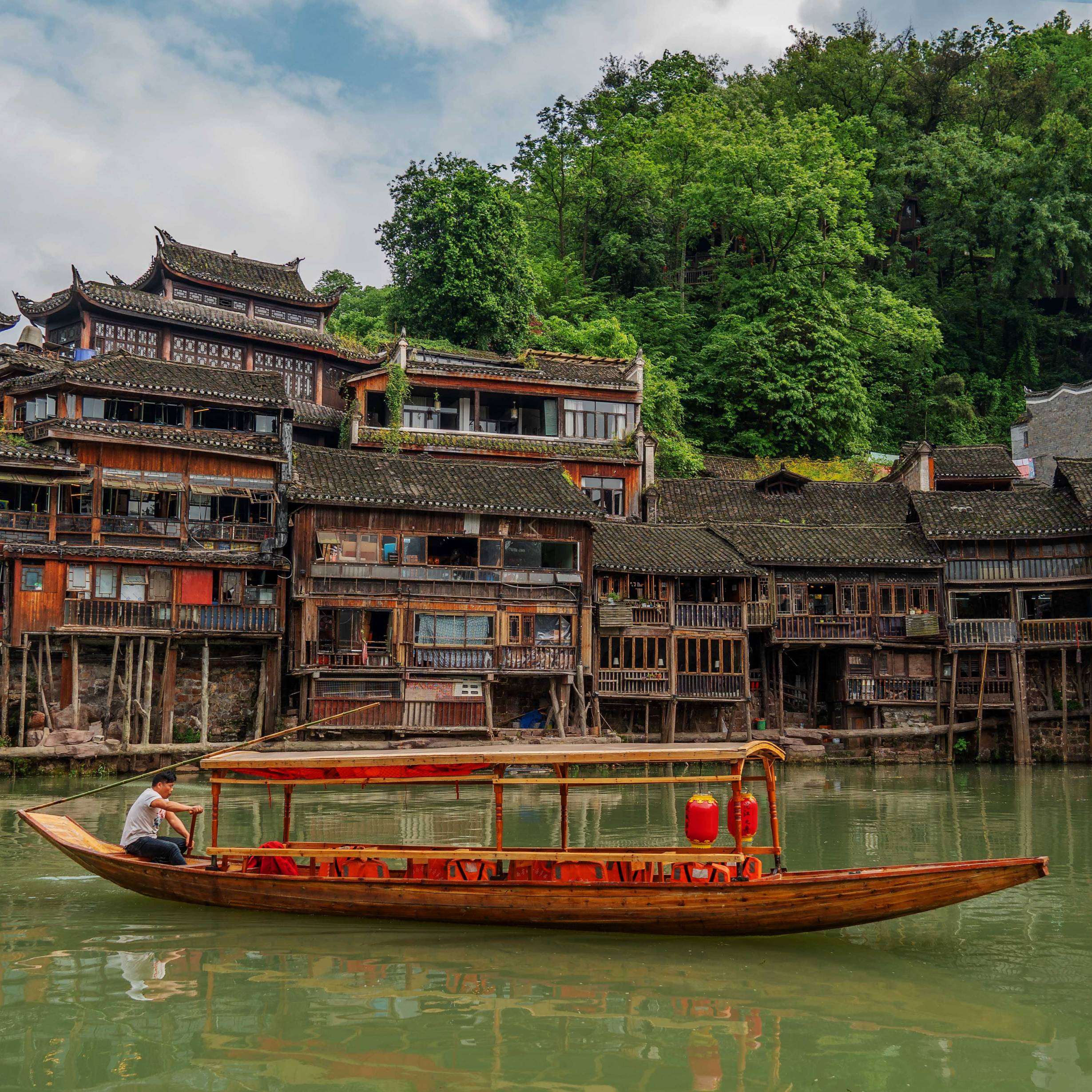 A Traditional Boat in Front of Old Houses in Fenghuang